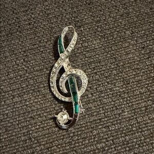 Elegant Silver and Green Treble Clef Brooch